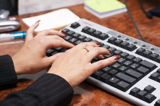 Hads with manicure and computer keyboard