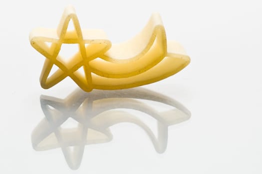 Christmas shooting stars noodle on white background with reflection
