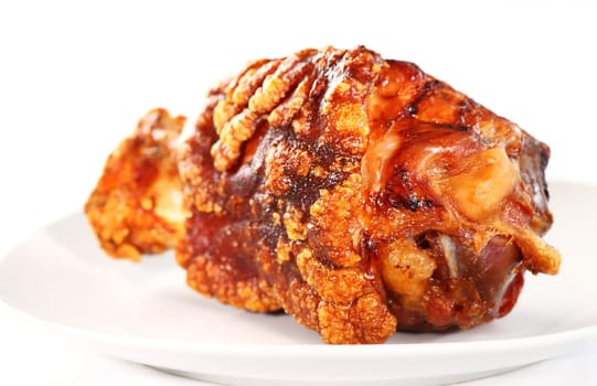 Grilled knuckle of pork on white background