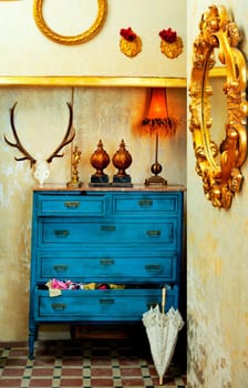 baroque grunge vintage house with blue drawer and golden mirror