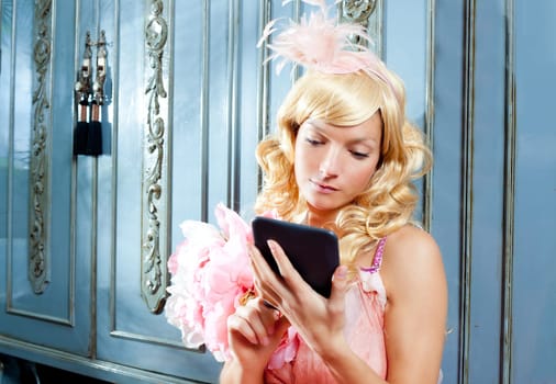 blond fashion princess woman reading ebook tablet with retro spring pink dress