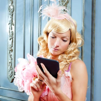 blond fashion princess woman reading ebook tablet with retro spring pink dress