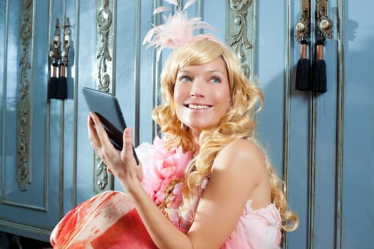blond fashion princess woman reading ebook tablet with retro spring pink dress