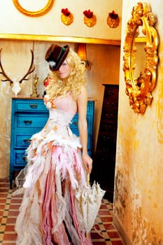 blond fashion woman in vintage grunge baroque house with umbrella