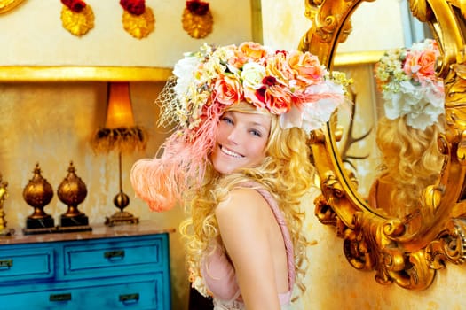 blond fashion woman with spring flowers hat in baroque grunge house