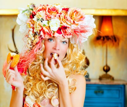 baroque fashion blonde woman eating bagel with flowers hat