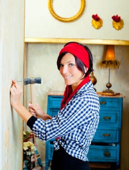 Diy fashion woman with nail and hammer on grunge house