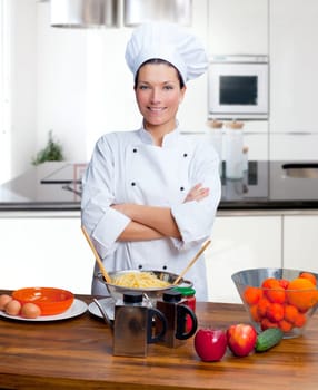 Chef woman portrait with white uniform in the kitchen