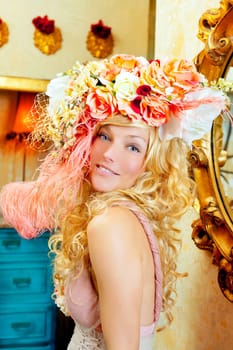 blond fashion woman with spring flowers hat in baroque grunge house