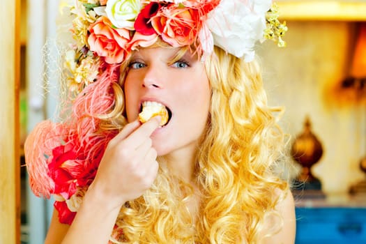 baroque fashion blonde woman eating bagel with flowers hat