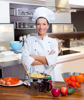 Chef woman portrait with white uniform in the kitchen