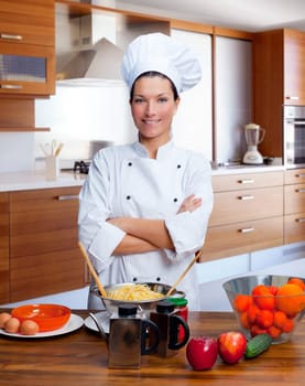 Chef woman portrait with white uniform in the kitchen