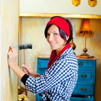 Diy fashion woman with nail and hammer on grunge house