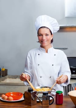 Chef woman portrait with white uniform in the kitchen