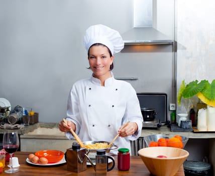 Chef woman portrait with white uniform in the kitchen