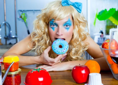 Blonde funny girl on kitchen eating blue donut with fashion makeup