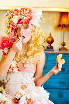 baroque fashion blonde woman eating bagel with flowers hat