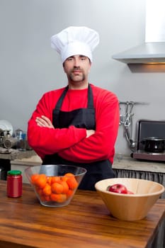 Chef man portrait with mustache in black and red on the kitchen