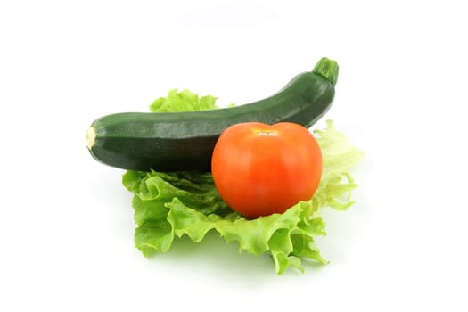 details of a fresh zucchini and tomato isolated on white on salad