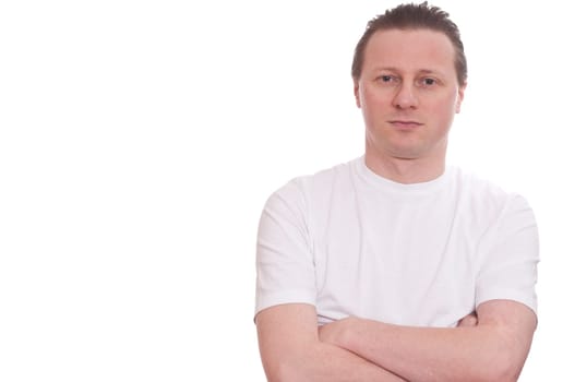 A man in a white T-shirt looks relaxed with a smile