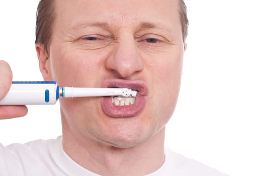 European with an electric toothbrush brushes his teeth