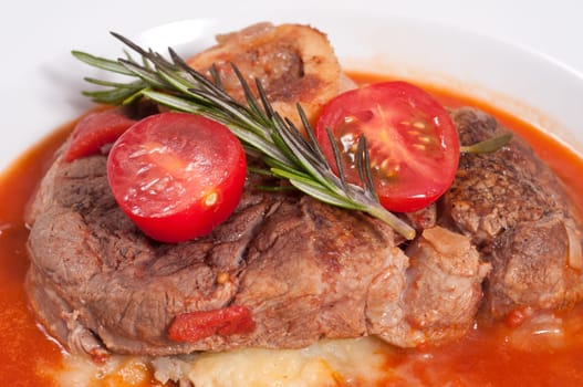 Braised veal shanks with rosemary and tomatoes and tomato sauce