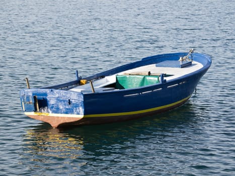 old wooden blue boat on the sea