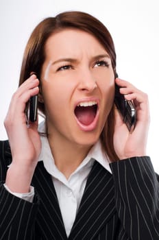 Young upset business woman talking on the mobile phone