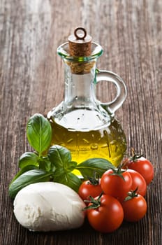 Mozzarella cheese, tomato, basil and olive oil close up