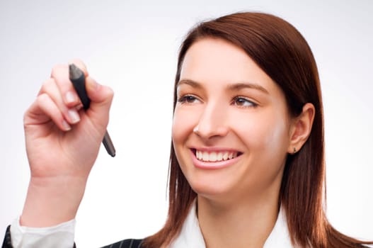 Young business woman writing on glass close up