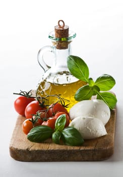 Fresh tomato, mozzarella, basil and olive oil close up