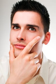 young handsome business man thinking close up