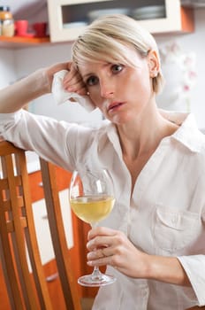 Sad beautiful young woman drinking wine close up