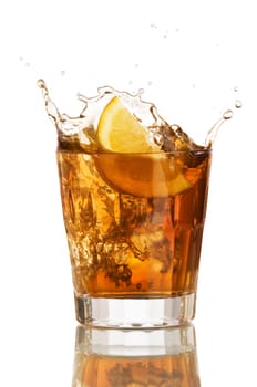 lemon slice falling in to glass with ice tea