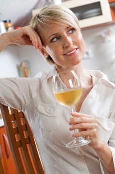 Young beautiful woman drinking white wine portrait