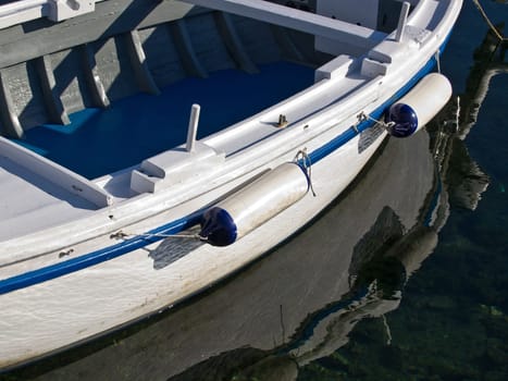 reflection of a boat bumper in the water