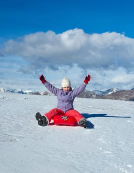 A girl sliding in the snow