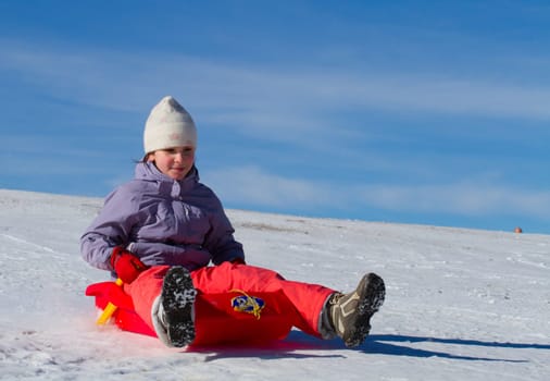 A girl sliding in the snow