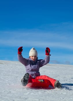 A girl sliding in the snow