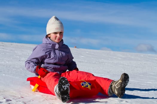 A girl sliding in the snow