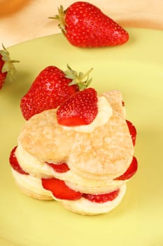 Heart shaped strawberries and custard millefeuille on a green plate. For a sweet Valentine&#039 s Day. Selective focus.
