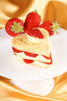 Heart shaped strawberries and custard millefeuille for a sweet Valentine&#039 s Day. Selective focus.