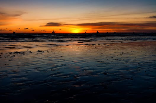 view over a tropical beach against a beautiful sunset