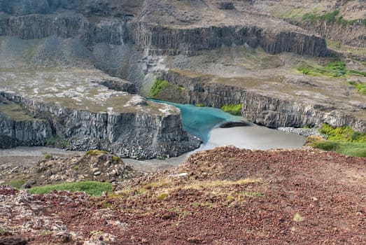 meeting of two rivers downstream from the Dettifoss waterfall in Iceland