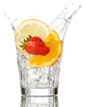 splashing orange, lemon and strawberry into a water glass