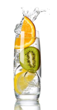 splashing orange, lemon and kiwi into a water glass