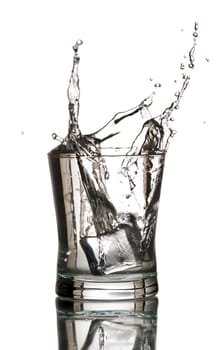 ice cube splashing in to glass close up