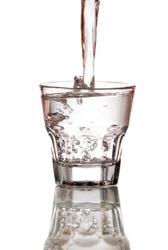 fresh water splashing into glass isolated on white