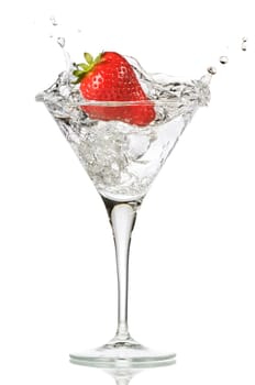 fresh splashing strawberry into a martini glass