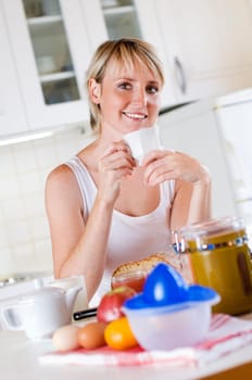 young woman drinking coffee for breakfast close up
